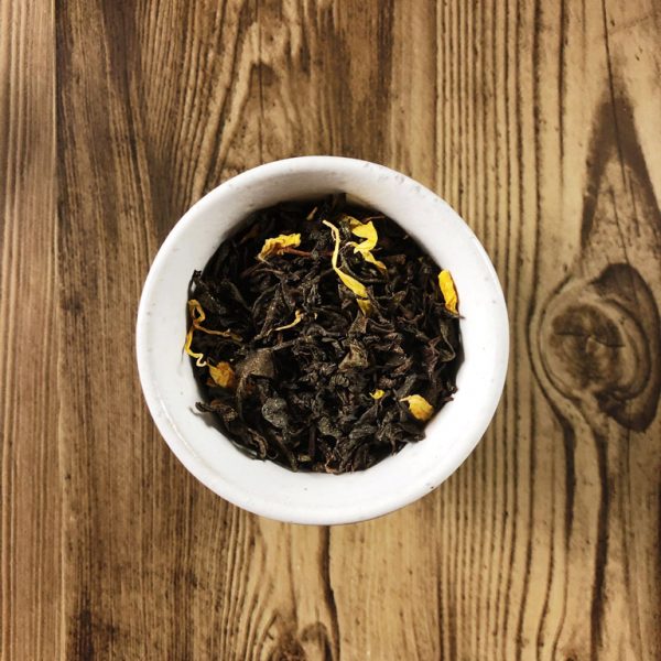 Midnight Cauldron black tea leaves in a teacup
