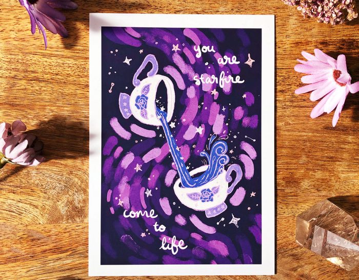 Image shows a printed art card featuring two cosmic teacups and the wrods "You are starfire come to life"