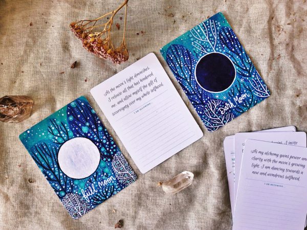 Full Moon and Dark moon cards shown with artwork facing up. Also shown is an example of a moon phase reverse side with affirmation text and space for writing personal affirmations.